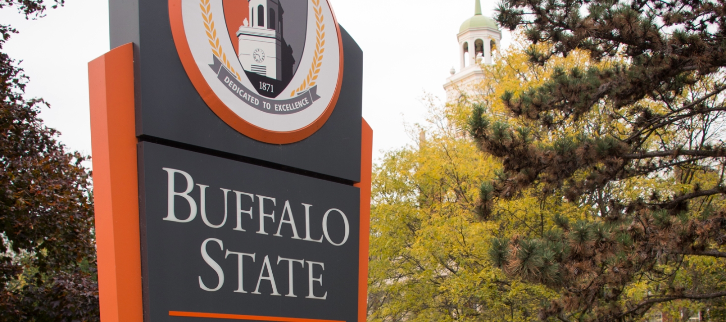 Buffalo State campus sign with Rockwell Hall tower